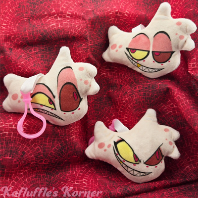 Plush keychain of Angel Dust with multiple expressions