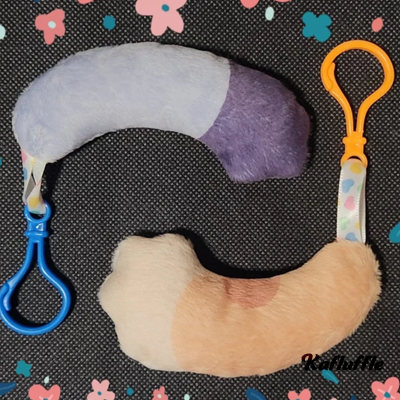 A blue dog tail and orange dog tail keychain