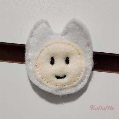 A felt boy with animal hood pin