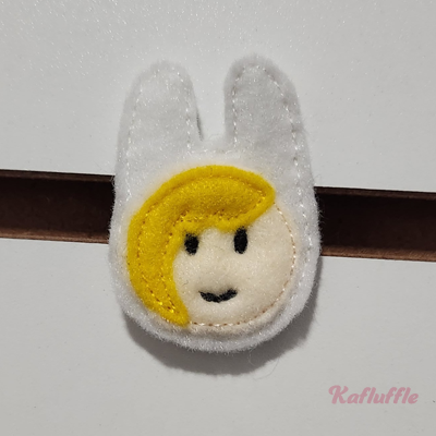 A felt girl  with animal hood pin